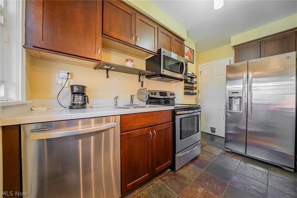 Kitchen with cabinets, counters and appliances