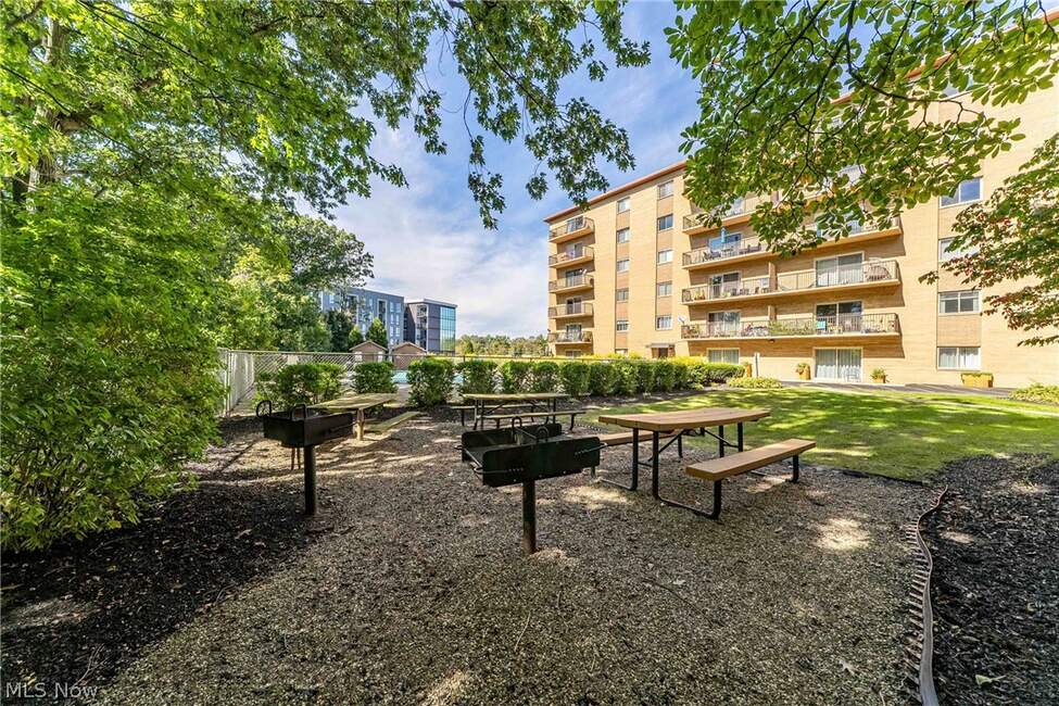 Picnic tables and landscaped common grounds at Hilroc Condos