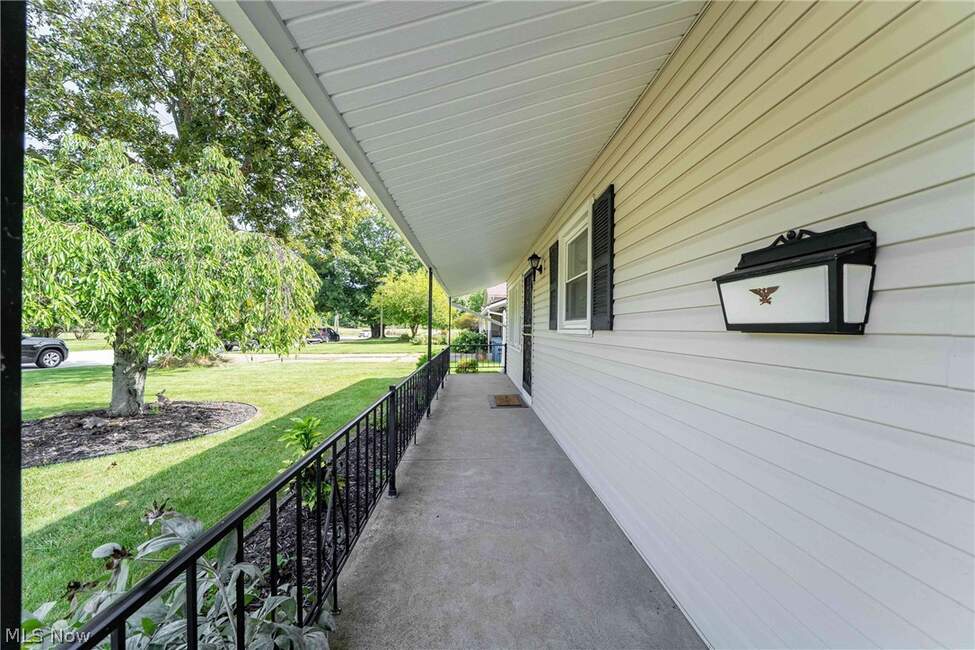The covered front porch and entry path at 6117 Yorktown Road