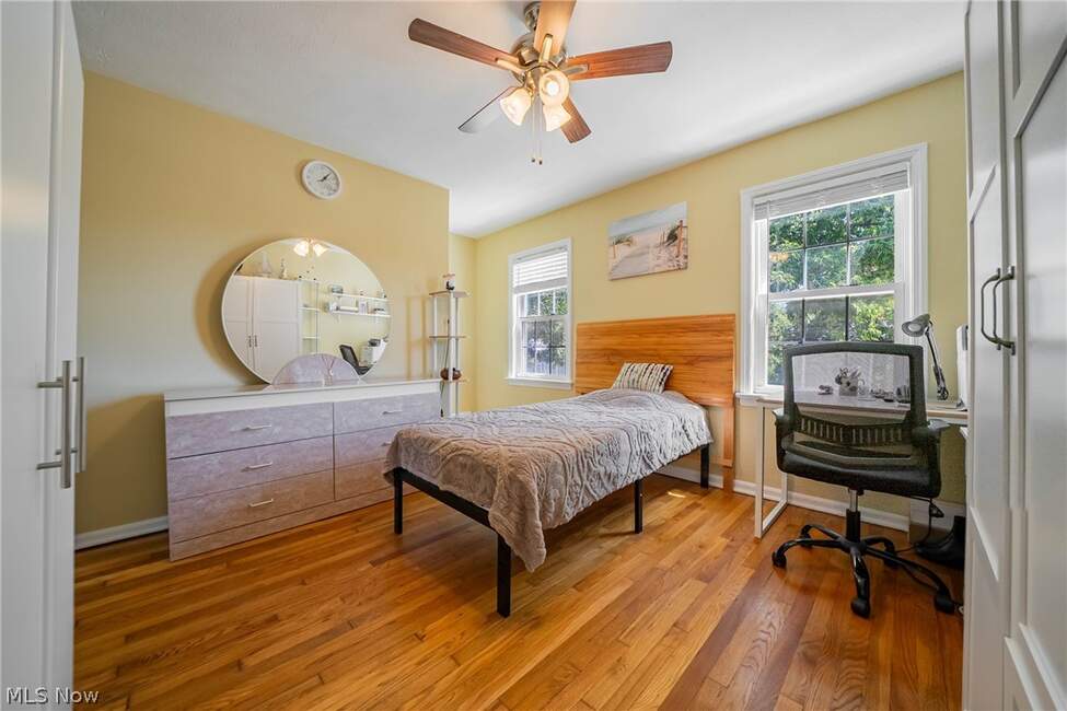 Bedroom with bed, dresser and windows