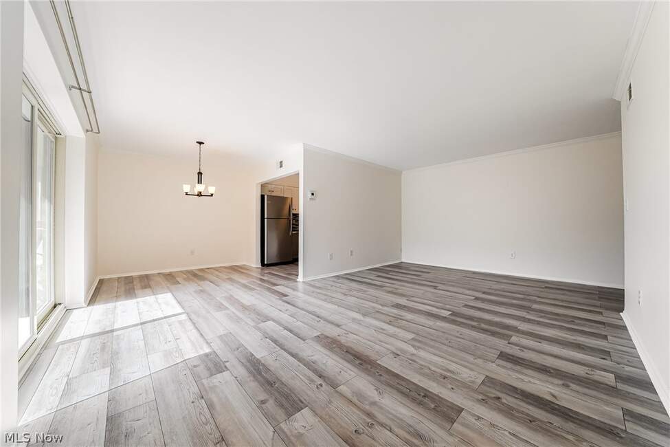 Unfurnished living and dining area with balcony doors at Unit 413