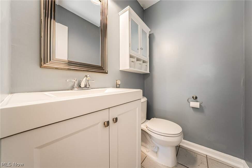 Half bathroom with vanity and toilet at Unit 413