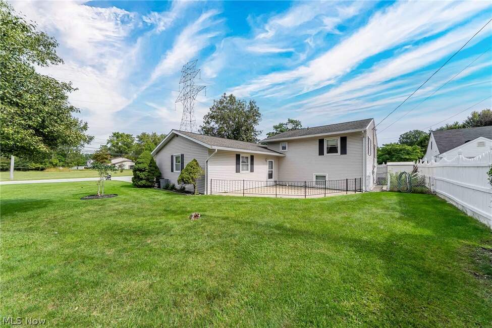 Rear exterior and fenced backyard